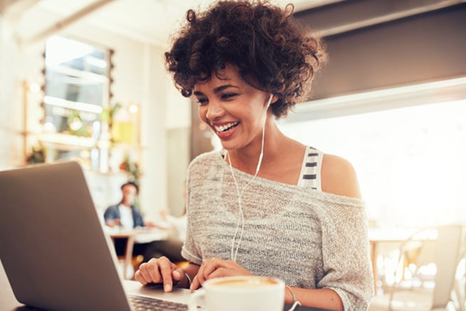 woman smiling while working on a pc