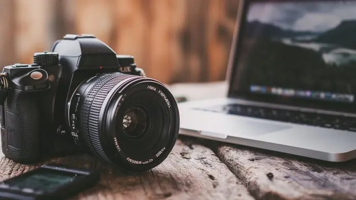 Camera in front of open laptop
