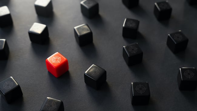 Red cube standing out among black cubes