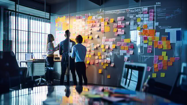 Workers prioritizing with sticky notes