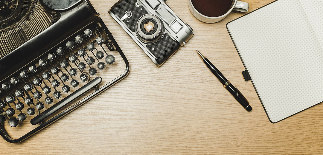 typewriter camera pen on desk