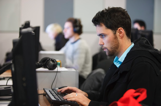 Man working at on marketing initiatives at computer